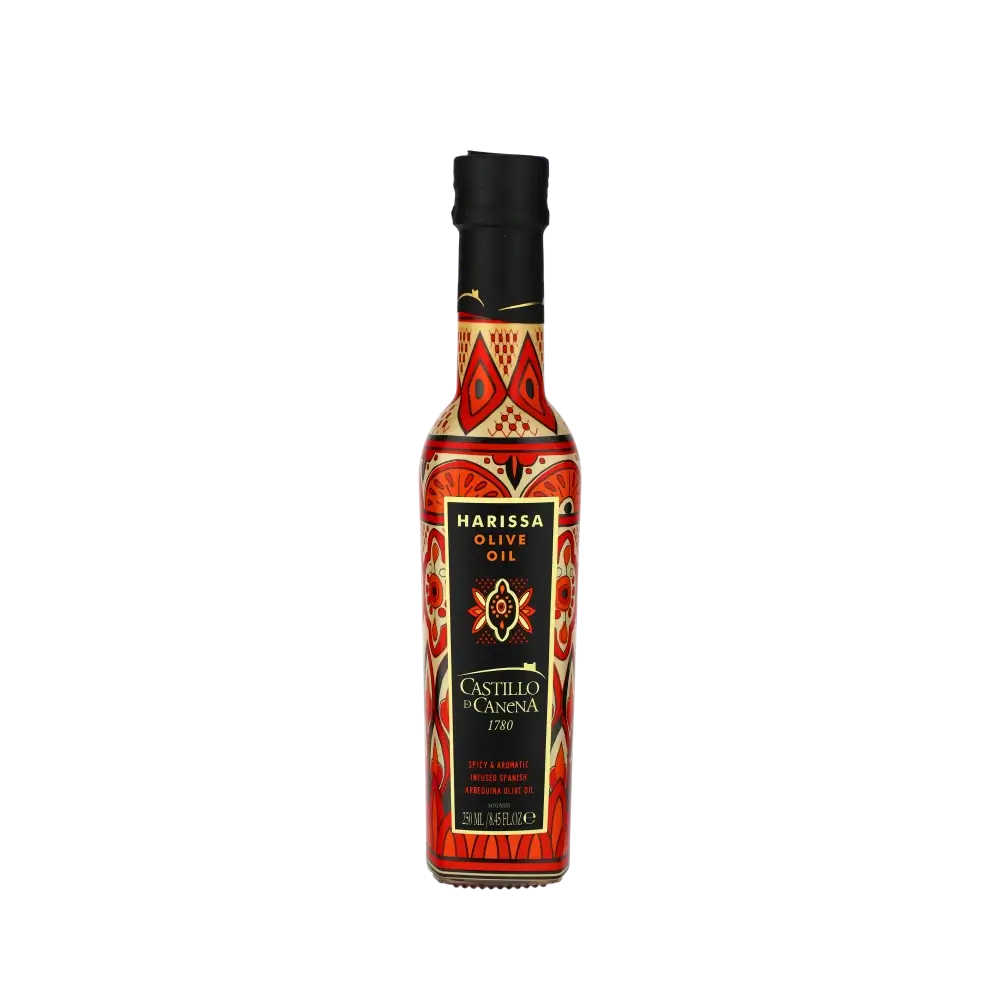 Flasche Castillo de Canena Harissa Olivenöl vor schwarzem Hintergrund.