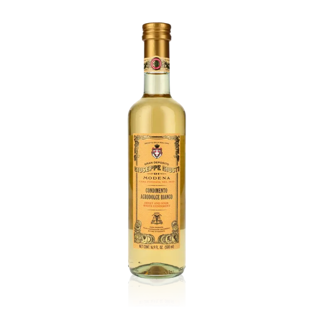 Giuseppe Giusti weißer Balsamico Essigflasche auf schwarzem Hintergrund.