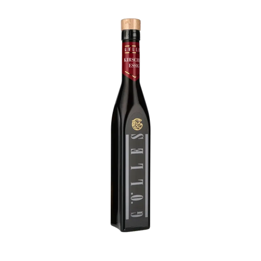 Gölles Kirschenessig Flasche vor schwarzem Hintergrund.