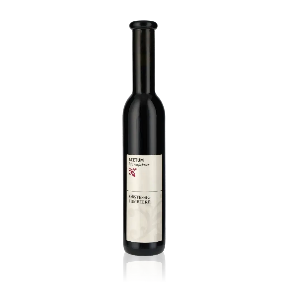 Flasche Acetum Manufaktur Himbeeressig vor schwarzem Hintergrund.