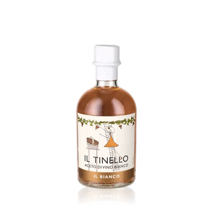 Weißweinessigflasche Il Tinello Il Bianco vor schwarzem Hintergrund.